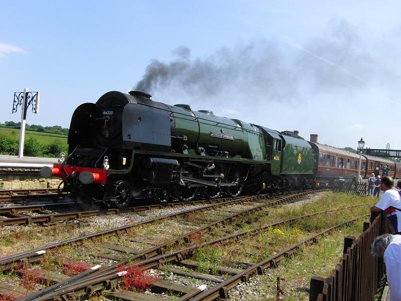 Bij het Midland Railway Center in Burrterley werd nog een 75-jarige jubilaris in het zonnetje gezet. Duchess of Sutherland, die exact driekwart eeuw eerder gebouwd was voor de LMS. Deze Princess Coronation class locomotief is een ‘klasgenoot' (class mate) van Duchess of Hamilton, die een paar jaar geleden geheel gestroomlijnd in haar oorspronkelijke outfit werd teruggebracht. Weer een andere gestroomlijnde Duchess had het snelheidsrecord voor stoomlocotieven in Engeland verbroken voordat Mallard dat in 1938 definitief vestigde.Duchess of Sutherland staat hier klaar voor vertrek in Swanwick Junction richting Butterley. Achteraan de trein liep een dieselloc mee in het kader van het 1960s weekend met gemengde tractie.