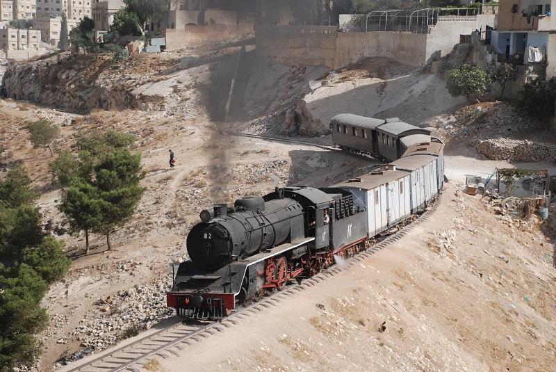 Tijdens Hedjaz-reis trekt Pacific 82 op 20 oktober 2008 onze gemengde excursietrein door de voorsteden van de Jordaanse hoofdstad Amman.