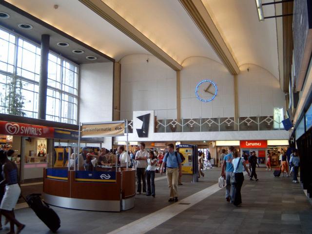 De de hal; daar waar vroeger de loketten waren, zijn later winkeltjes gekomen. Ook aan de kant van de voorgevel zijn winkeltjes gekomen.Verder stond in het midden de informatiebalie van NS.De ruimtelijke werking van de hal uit de beginjaren was daarmee flink verknoeid.Foto: N. Booij Periode: 2004